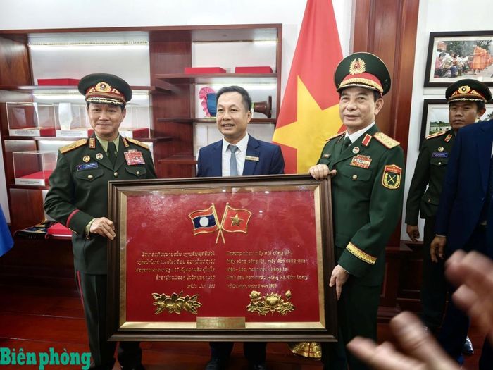 Đại tướng Phan Văn Giang và Đại tướng Khăm Liêng - Ụ Thạ Cay Sỏn tặng quà lưu niệm Ban Quản lý Khu Di tích quốc gia đặc biệt Kim Liên. Ảnh: Thành Duy