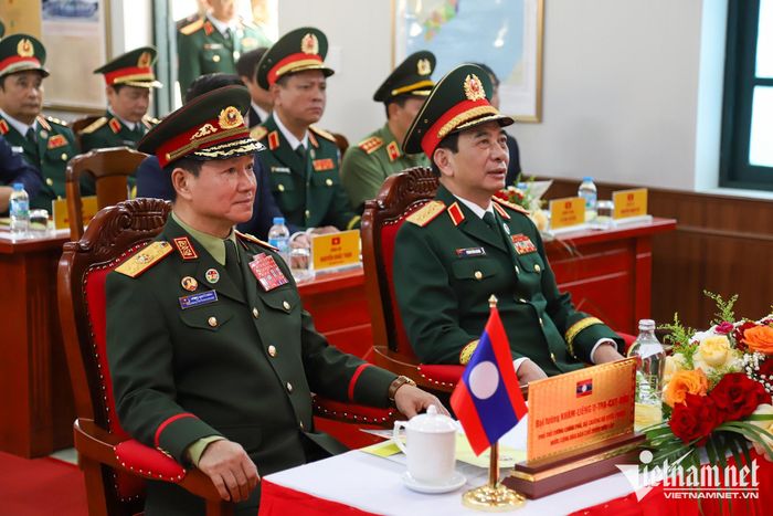 Hai Phó Thủ tướng, Bộ trưởng Quốc phòng Việt Nam - Lào nghe báo cáo kết quả công tác của đơn vị