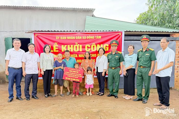 Thành ủy viên, Phó Chủ tịch UBND thành phố, Trưởng ban Chỉ đạo 515 thành phố Nguyễn Thị Hoàng cùng đại diện sở ngành, địa phương trao bảng tượng trưng kinh phí hỗ trợ sửa chữa nhà ở cho gia đình ông Phạm Thanh Trình. Ảnh: CTV