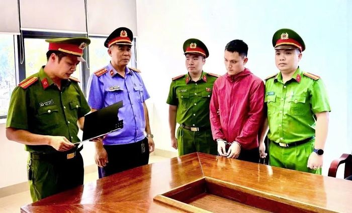 Cơ quan Cảnh sát điều tra Công an tỉnh tống đạt quyết định bắt bị can để tạm giam đối với Lê Văn Thành (áo đỏ).