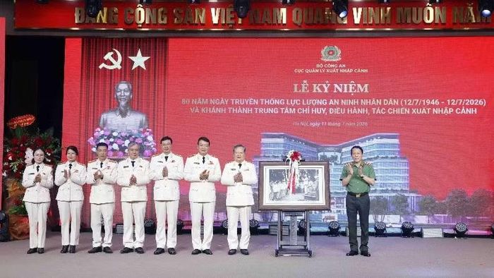 Bộ trưởng Lương Tam Quang trao bức tranh “Bác Hồ với lực lượng An ninh nhân dân năm 1961” tặng Cục Quản lý xuất nhập cảnh.