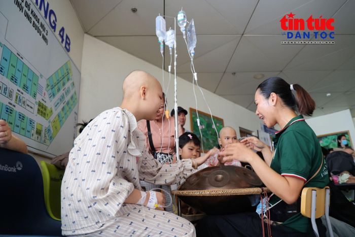 Chị Nguyễn Thị Ngọc Vy, Trưởng nhóm thiện nguyện Ươm Mầm hướng dẫn các em chơi nhạc cụ handpan.