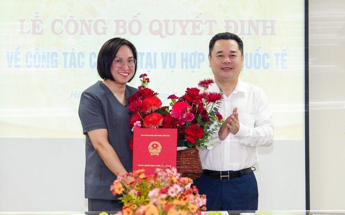 Phó Thống đốc NHNN Nguyễn Ngọc Cảnh tặng hoa và trao Quyết định bổ nhiệm cho bà Nguyễn Thị Trà Vi. Ảnh: NHNN