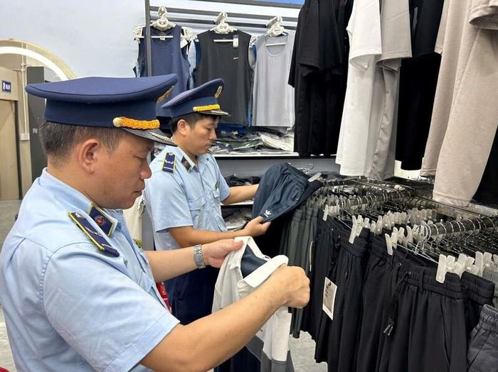 Cán bộ Đội Quản lý thị trường số 8, Chi cục Quản lý thị trường Tuyên Quang kiểm tra hàng hóa giả mạo nhãn hiệu. Ảnh: QLTT Tuyên Quang