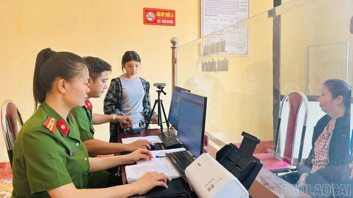 Cán bộ Công an xã tiếp nhận hồ sơ cấp tài khoản định danh điện tử cho người dân.