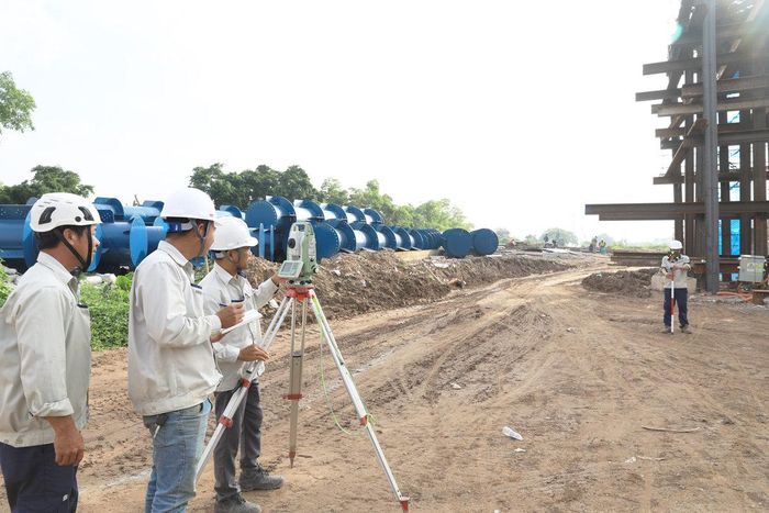 Kỹ sư Bùi Minh Phong (thứ 3 trái sang) cùng đồng nghiệp tập trung đo tọa độ vị trí các hạng mục thi công.