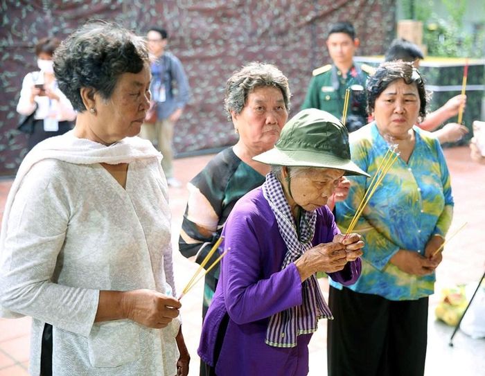 Những người nhận là thân nhân của liệt sĩ Huỳnh Văn Quên đến Công viên Lê Thị Riêng thắp nén hương tưởng nhớ