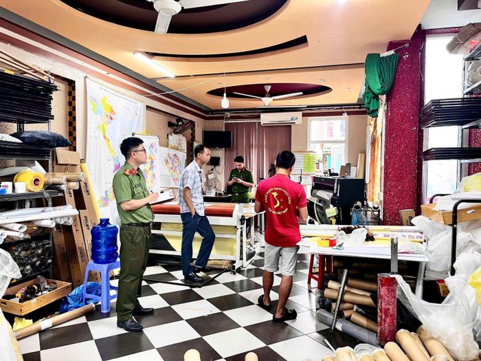 Lực lượng chức năng kiểm tra cơ sở in của ổng Trần Xuân Sơn. (Ảnh: CAHY).