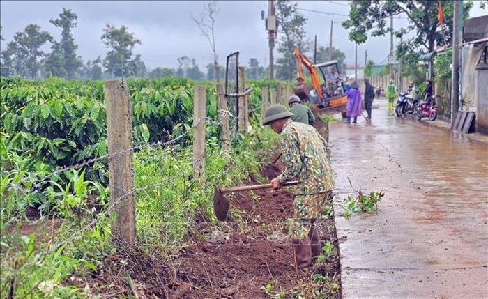 Cán bộ, chiến sĩ và người dân thu gom cành cây, phế thải sau phát quang, giữ gìn vệ sinh môi trường, chủ động phòng, chống sốt xuất huyết tại Gia Lai.