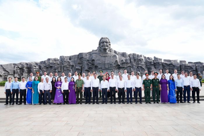 Các đại biểu chụp hình lưu niệm tại Tượng đài Mẹ Việt Nam anh hùng. Ảnh: HỒ QUÂN