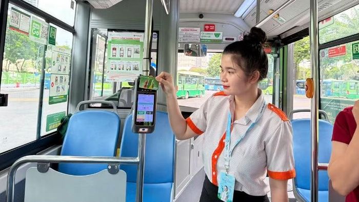 Nhân viên phục vụ hướng dẫn hành khách cài đặt ứng dụng MultiGo và các phương thức thanh toán điện tử. Tuy nhiên, trong thời gian từ ngày 1/7 đến cuối tháng 9 thành phố chưa kiểm tra các giấy tờ tùy thân. (Ảnh: QUÝ HIỀN)