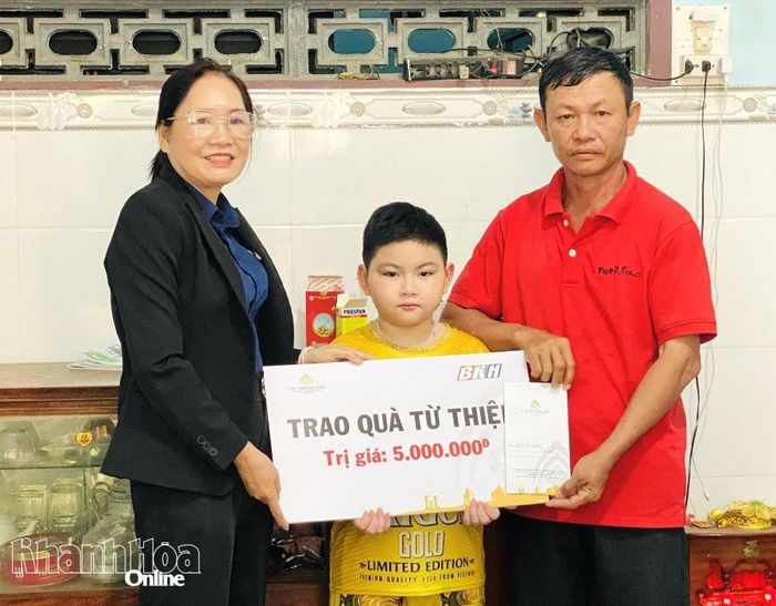 Đại diện Công ty Cổ phần Đầu tư Champagroup - Khu du lịch Champa Island Nha Trang trao tiền ủng hộ cho gia đình cháu Nguyễn Quốc Huy.
