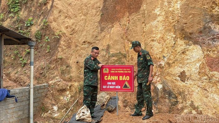 Cán bộ, chiến sĩ Ban Chỉ huy Quân sự phường Văn Phú cắm bổ sung biển cảnh báo tại các điểm có nguy cơ sạt lở cao.