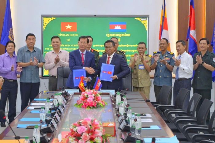 Ban chuyên trách 2 tỉnh ký kết biên bản bàn giao, tiếp nhận hài cốt liệt sĩ. Ảnh: Phương Vũ