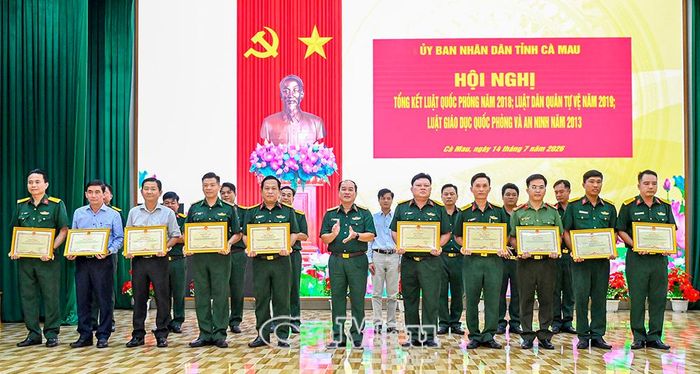 Thiếu tướng Nguyễn Văn Ngành, Chỉ huy trưởng Bộ Chỉ huy Quân sự tỉnh, trao bằng khen của Chủ tịch UBND tỉnh cho các tập thể, các nhân đã có thành tích xuất sắc trong triển khai thực hiện Luật Quốc phòng năm 2018.