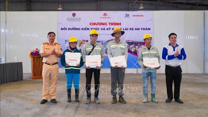 Ban Tổ chức trao thưởng cho các cá nhân đạt kết quả cao trong phần kiểm tra kiến thức pháp luật về trật tự, an toàn giao thông tại chương trình. Ảnh: Minh Phú - TTXVN