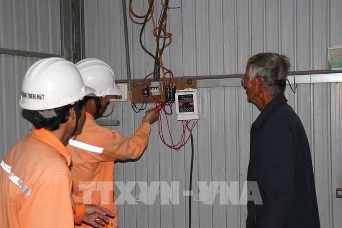 Nhân viên Điện lực Cư Jút kiểm tra an toàn điện của gia đình ông Lê Văn Lộc, thôn Hợp Tân, xã biên giới Đắk Wil (tỉnh Lâm Đồng). Ảnh Thanh Vũ – TTXVN