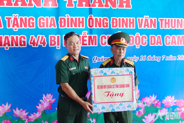 Đại tá Nguyễn Đình Khiêm, Phó chính ủy Bộ CHQS tỉnh Quảng Ninh, trao quà tặng gia đình ông Đinh Văn Thung.