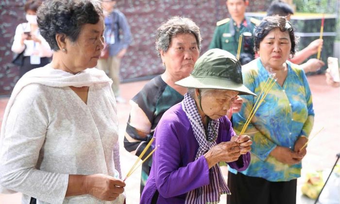 Bà Nguyễn Thị Lệ (áo tím - người từng có hẹn ước và chờ đợi liệt sĩ Huỳnh Văn Quên gần 60 năm qua) theo gia đình liệt sĩ đến Công viên Lê Thị Riêng thắp hương tưởng niệm các Anh hùng liệt sĩ vừa được tìm thấy hài cốt tại đây. Ảnh: Thúy Liễu.