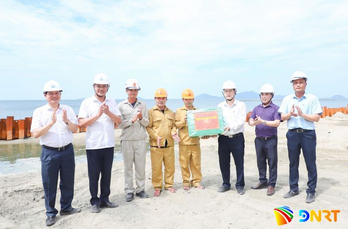 Lãnh đạo thành phố tặng quà đơn vị thi công Dự án khắc phục xói lở và bảo vệ bền vững bờ biển Hội An. Ảnh: NGỌC PHÚ