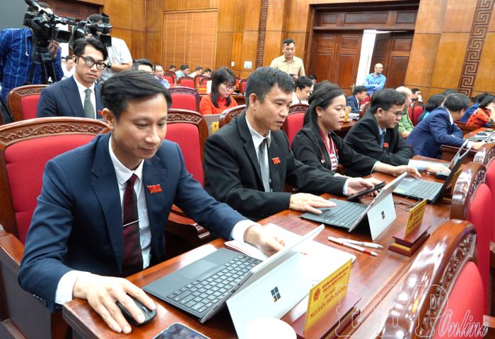 Đại biểu HĐND tỉnh biểu quyết thông qua các nghị quyết trên máy tính.
