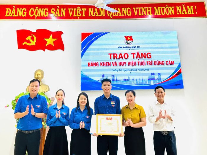 Trao Huy hiệu "Tuổi trẻ dũng cảm" cho em Lê Đức Trung vì có hành động dũng cảm cứu người đuối nước - Ảnh M.H