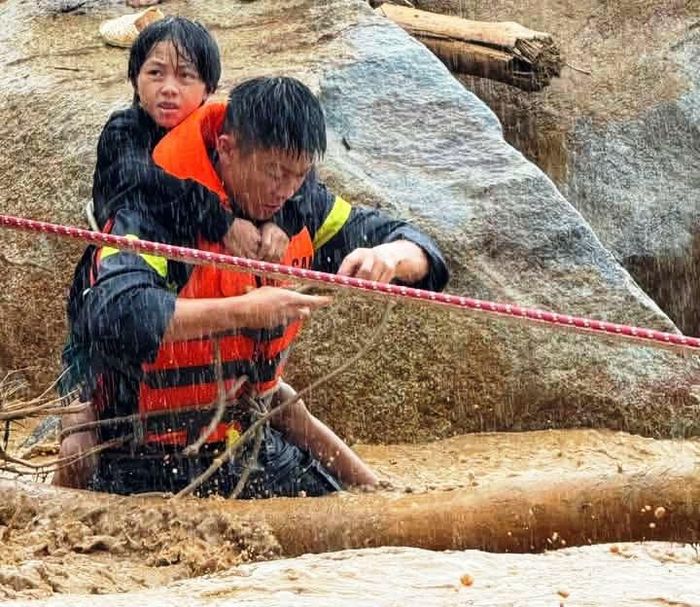 Cảnh sát đưa người mắc kẹt đến nơi an toàn. Ảnh: CACC