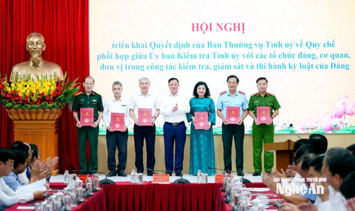 Bí thư Tỉnh ủy Nguyễn Khắc Thận trao Quyết định của Ban Thường vụ Tỉnh ủy về Quy chế phối hợp giữa Ủy ban Kiểm tra Tỉnh ủy với các cơ quan, đơn vị. Ảnh: T.L