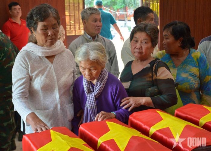 Bà Nguyễn Thị Lệ và thân nhân viếng các liệt sĩ vừa được quy tập tại Công viên Lê Thị Riêng. Ảnh: qdnd.vn