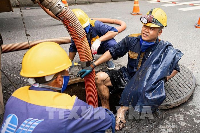 Kết thúc một ca làm thu gom rác dưới cống ngầm của các công nhân Công ty TNHH MTV Thoát nước Hà Nội. Ảnh: Tiến Long/TTXVN phát