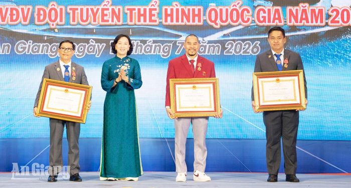 Phó Chủ tịch UBND tỉnh An Giang Nguyễn Thị Minh Thúy trao Huân chương Lao động hạng Nhất cho các vận động viên, huấn luyện viên.