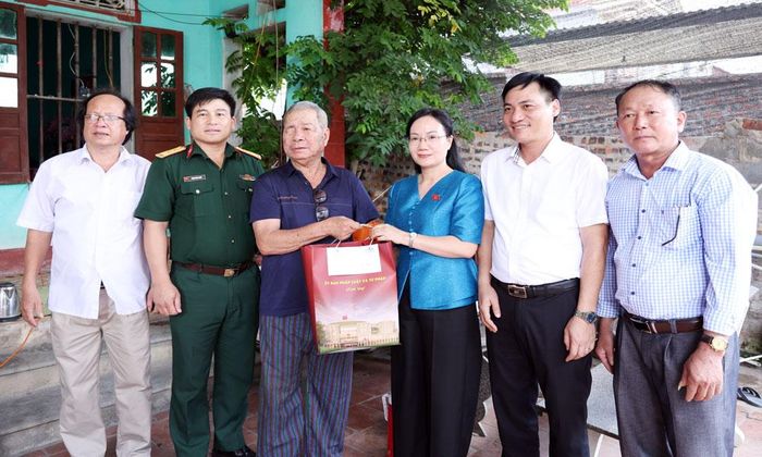  Đồng chí Đỗ Thị Việt Hà cùng đại diện Đảng ủy, HĐND, UBND xã Cẩm Lý tặng quà thương binh Nguyễn Văn Nga. 