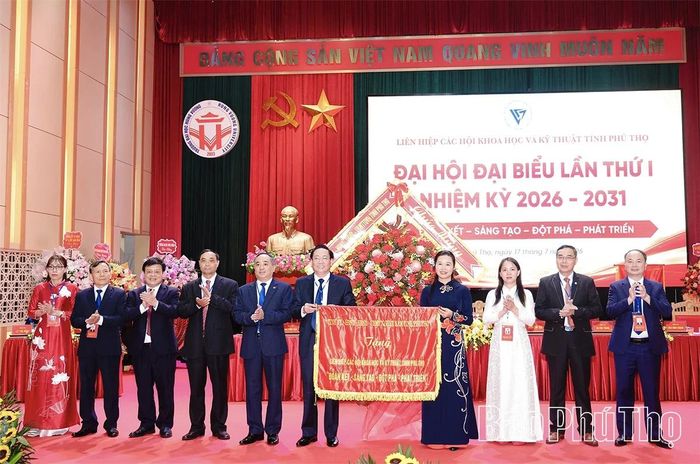 Đồng chí Bùi Thị Minh - Phó Bí thư Tỉnh ủy, Chủ tịch Ủy ban MTTQ Việt Nam tỉnh tặng hoa và trao bức trướng chúc mừng Đại hội.