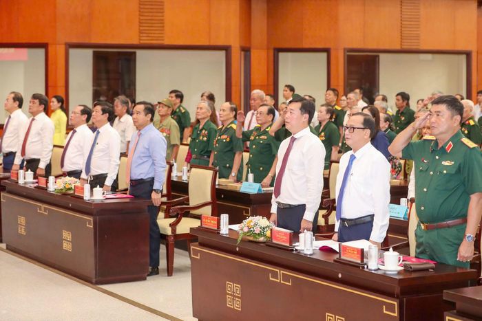 Các đại biểu làm lễ chào cờ tại buổi họp mặt người có công tiêu biểu tại TP. Hồ Chí Minh. Ảnh: Tiến Long
