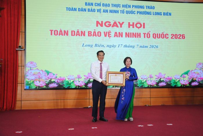 Ủy viên Ban thường vụ Thành ủy, Chủ tịch Ủy ban Mặt trận Tổ quốc Việt Nam thành phố Hà Nội Bùi Huyền Mai trao Bằng khen của Chủ tịch UBND thành phố Hà Nội tặng nhân dân và cán bộ phường Long Biên về thành tích trong phong trào “Toàn dân bảo vệ an ninh Tổ quốc”. Ảnh: Thế Dương