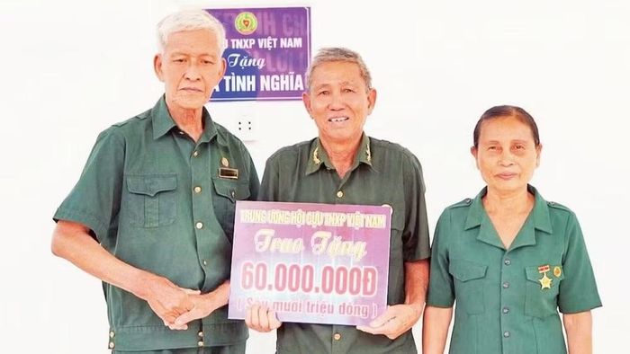 Vợ chồng ông Nguyễn Xuân Thanh trong ngày nhận Nhà nghĩa tình đồng đội. (Ảnh: PHẠM HẠNH)