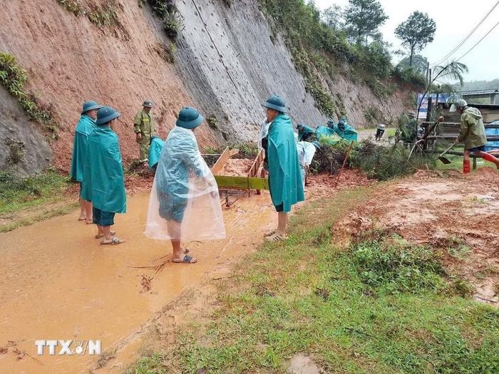 Các lực lượng khắc phục điểm sạt lở đường giao thông ở xã Púng Luông. (Ảnh: TTXVN phát)