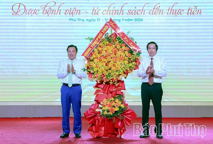 Đồng chí Phó Chủ tịch UBND tỉnh Nguyễn Huy Ngọc tặng lẵng hoa chúc mừng hội thảo.
