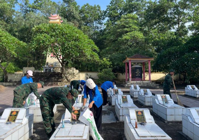 Các lực lượng tham gia chỉnh trang từng phần mộ và khuôn viên nghĩa trang liệt sĩ trên địa bàn. Ảnh: M.H