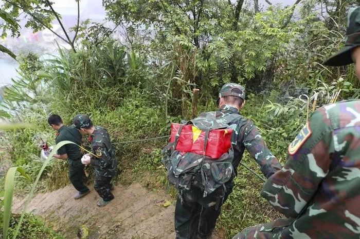 Đường lên mộ dốc đứng, trơn trượt nên khi đưa các liệt sĩ xuống cán bộ chiến sĩ Bộ Chỉ huy quân sự tỉnh Điện Biên phải bám vào dây chằng theo cột để đi từng bước.