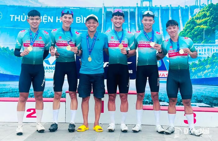 Huấn luyện viên đội xe đạp Đồng Nai Đặng Ngọc Tú chia vui với các chàng trai đạt huy chương vàng đồng đội nam nội dung xuất phát đồng hành. Ảnh: NVCC