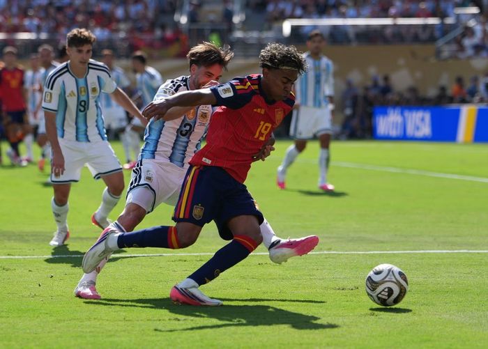 Tiền đạo Tây Ban Nha Lamine Yamal đi bóng trong sự truy cản của tuyển thủ Argentina. (Ảnh: THX/TTXVN)
