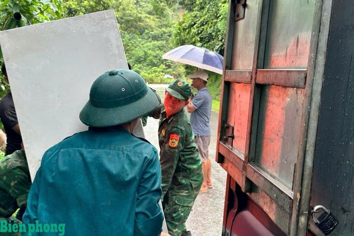 Cán bộ, chiến sĩ Đồn Biên phòng Mường Mươn di dời đồ dùng học tập, vật chất của điểm trường mầm non đến nơi an toàn. Ảnh: Anh Dũng