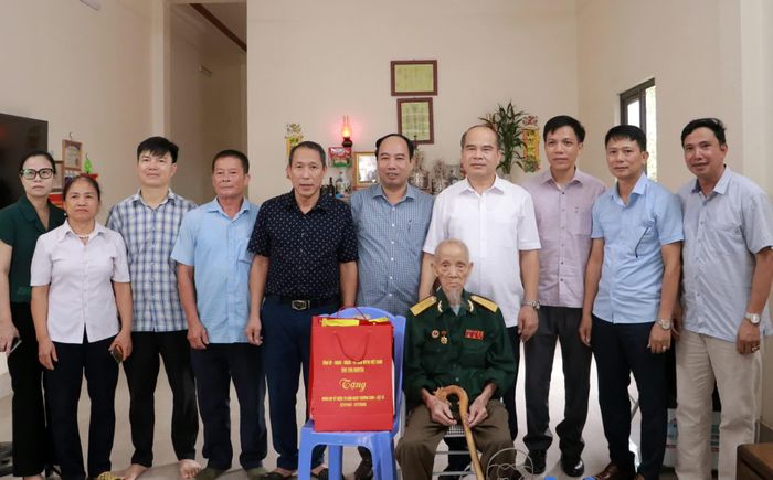 Đoàn công tác tặng quà ông Nguyễn Văn Quảng, người có công với cách mạng, ở xóm Bằng Cầu, xã Kha Sơn.