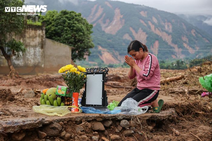 Chị Phương bên cạnh bàn thờ tạm ngay trên nền nhà cũ của bà Mai.