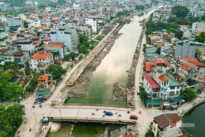 Toàn cảnh tuyến hạ lưu sông Kim Ngưu nhìn từ trên cao, với công trường kéo dài qua khu dân cư.