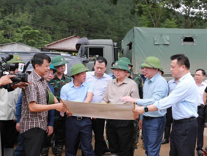 Lãnh đạo tỉnh Lai Châu báo cáo với Phó Thủ tướng Chính phủ Hồ Quốc Dũng về khu vực bắt đầu xảy ra lũ quét. Ảnh: Quý Trung – TTXVN