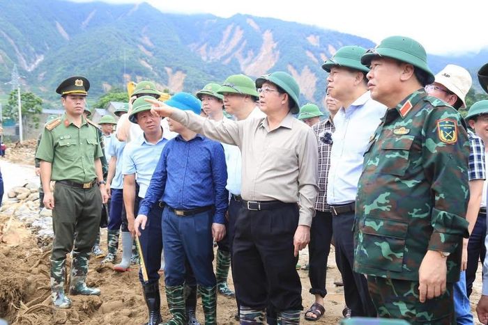 Đoàn công tác của Chính phủ do Phó Thủ tướng Hồ Quốc Dũng làm trưởng đoàn, kiểm tra việc khắc phục thiên tai ở xã Mường Than, sáng 21-7. Ảnh: UBND XÃ MƯỜNG THAN