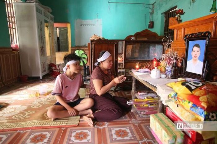 Mẹ con chị Thúy bên di ảnh của chồng.