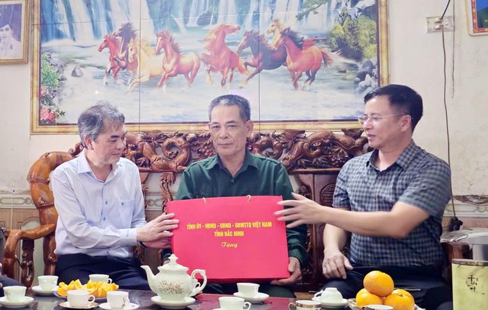 Đồng chí Vũ Minh Hiếu tặng quà bệnh binh Bùi Huy Thanh, thôn Gàng.